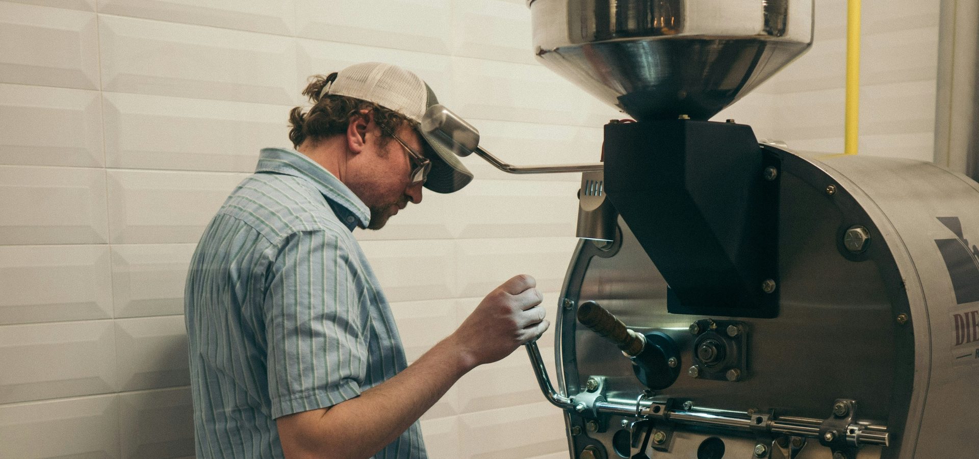 A coffee roaster watching the beans in his workshop